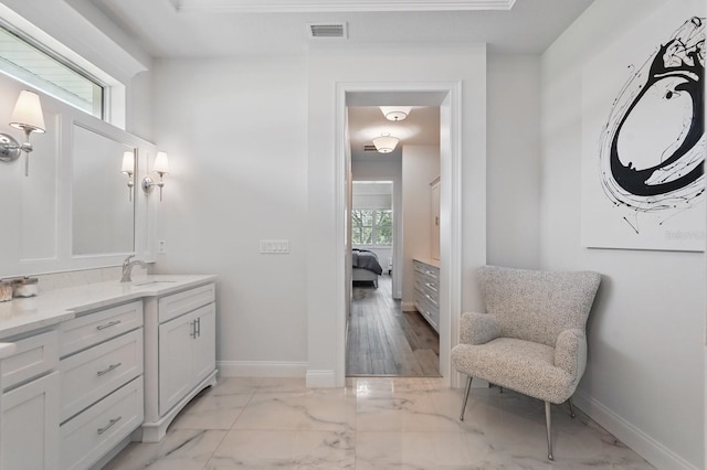 17 Kingfisher Ln, Palm Coast, FL 32137 - ensuite bathroom with baseboards, marble finish floors, and vanity