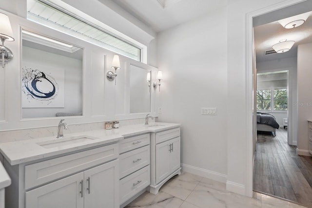 17 Kingfisher Ln, Palm Coast, FL 32137 - full bath featuring baseboards, marble finish floors, double vanity, and ensuite bathroom
