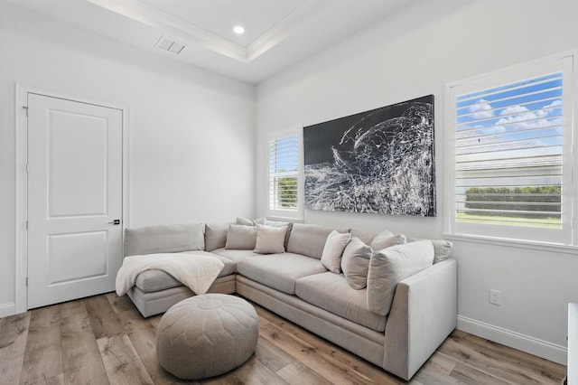 17 Kingfisher Ln, Palm Coast, FL 32137 - living room with light wood-style floors, a tray ceiling, ornamental molding, baseboards, and recessed lighting