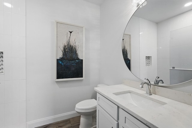 17 Kingfisher Ln, Palm Coast, FL 32137 - bathroom featuring vanity, toilet, baseboards, and wood finished floors