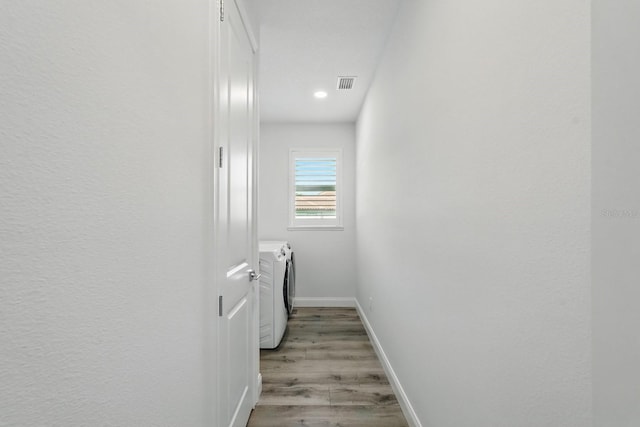 17 Kingfisher Ln, Palm Coast, FL 32137 - laundry area with washing machine and clothes dryer, baseboards, light wood-type flooring, and recessed lighting