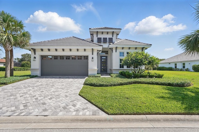 17 Kingfisher Ln, Palm Coast, FL 32137 - view of front facade featuring decorative driveway, an attached garage, a front yard, stucco siding, and a tile roof