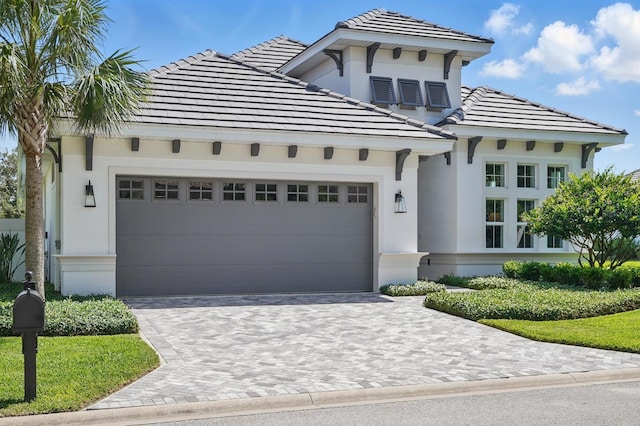 17 Kingfisher Ln, Palm Coast, FL 32137 - view of front of house with an attached garage, driveway, and stucco siding