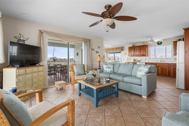 6973 N Oceanshore Blvd, Palm Coast, FL 32137 - living room with a ceiling fan and light tile patterned flooring