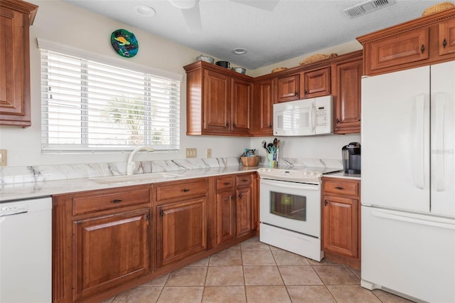6973 N Oceanshore Blvd, Palm Coast, FL 32137 - kitchen featuring white appliances, a sink, and brown cabinetry