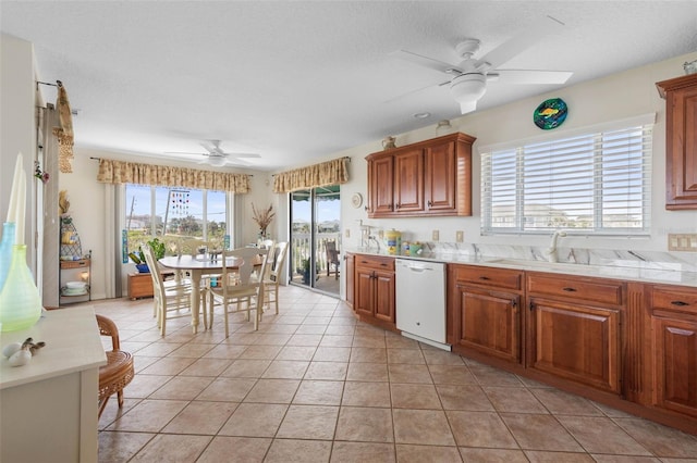 6973 N Oceanshore Blvd, Palm Coast, FL 32137 - kitchen with white dishwasher, a ceiling fan, light countertops, and brown cabinets