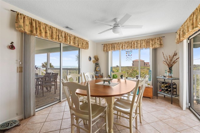 6973 N Oceanshore Blvd, Palm Coast, FL 32137 - dining room with a ceiling fan, light tile patterned floors, and a textured ceiling