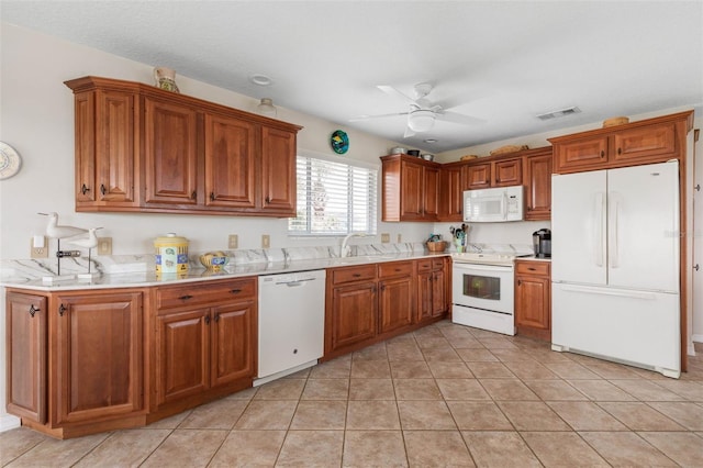 6973 N Oceanshore Blvd, Palm Coast, FL 32137 - kitchen featuring white appliances, ceiling fan, brown cabinetry, light countertops, and light tile patterned floors