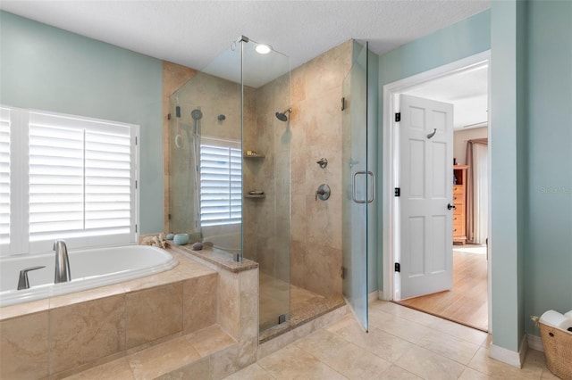 6973 N Oceanshore Blvd, Palm Coast, FL 32137 - bathroom featuring a garden tub, a stall shower, and tile patterned floors