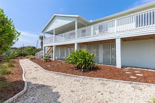 6973 N Oceanshore Blvd, Palm Coast, FL 32137 - back of house with a balcony and stairs