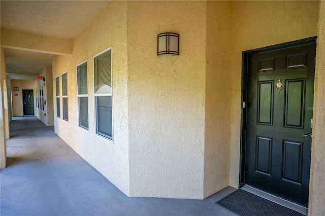 property entrance with stucco siding