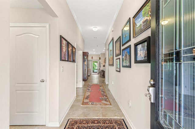 corridor featuring baseboards and crown molding