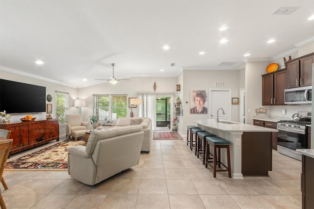living room with ceiling fan, recessed lighting, light tile patterned floors, ornamental molding, and baseboards