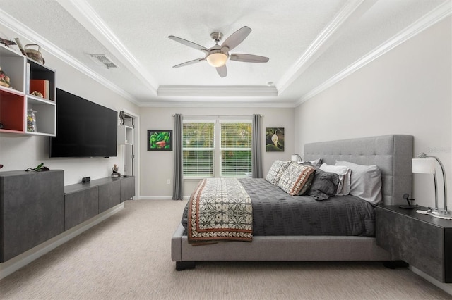 bedroom with a tray ceiling, ornamental molding, light carpet, ceiling fan, and baseboards