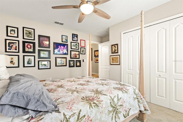 carpeted bedroom featuring multiple closets and ceiling fan