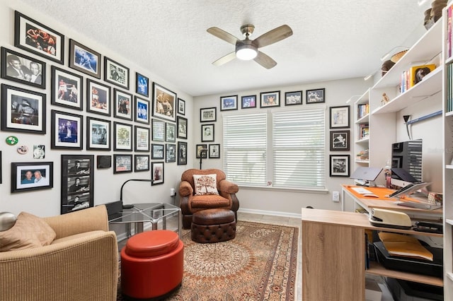 tiled office space with a ceiling fan and a textured ceiling
