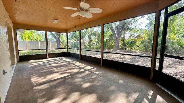 unfurnished sunroom featuring a ceiling fan