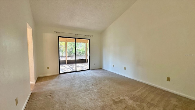 unfurnished room with carpet, baseboards, and a textured ceiling
