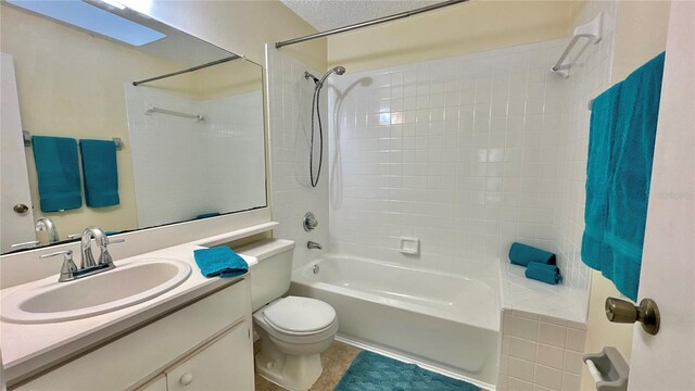 bathroom featuring toilet, shower / bath combination, vanity, tile patterned flooring, and a textured ceiling