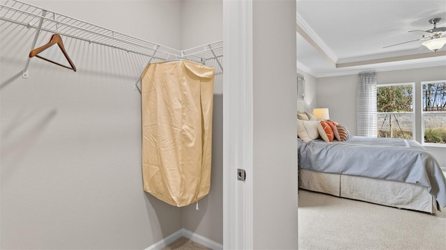 bedroom featuring ornamental molding, carpet flooring, baseboards, and a raised ceiling