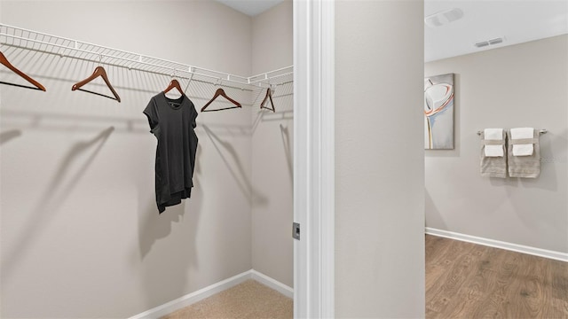 spacious closet featuring visible vents and wood finished floors