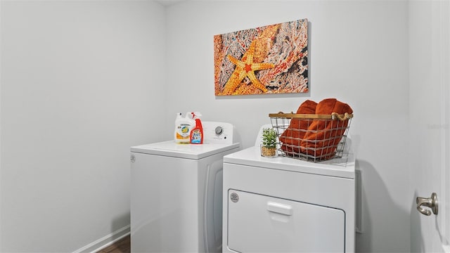 laundry room featuring laundry area, washer and clothes dryer, and baseboards