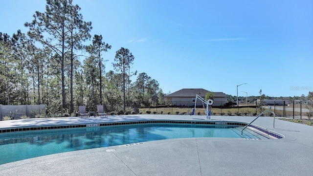 pool featuring a patio area and fence