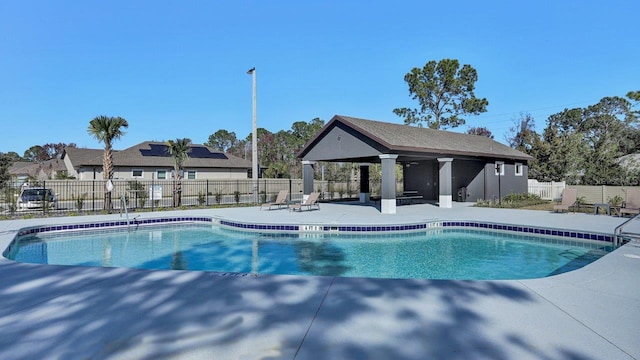pool featuring a gazebo, fence, and a patio