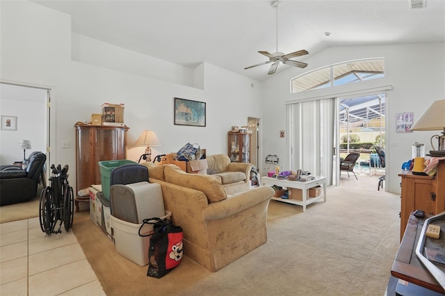 1956 Southern Dunes Blvd, Haines City, FL 33844 - living room with ceiling fan, lofted ceiling, light tile patterned floors, and light carpet