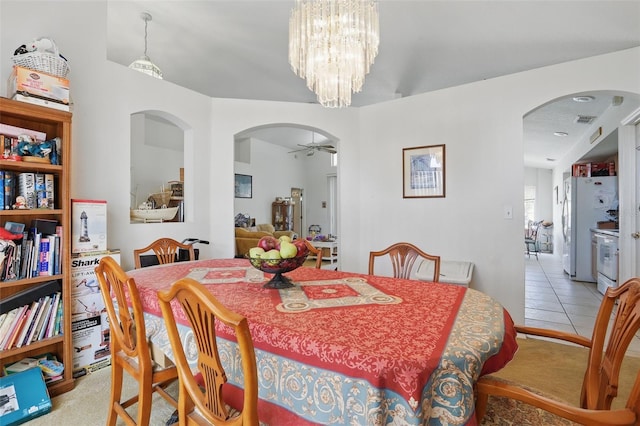 1956 Southern Dunes Blvd, Haines City, FL 33844 - dining area with tile patterned flooring, arched walkways, a chandelier, and a ceiling fan