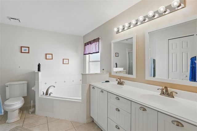 1956 Southern Dunes Blvd, Haines City, FL 33844 - bathroom featuring a garden tub, tile patterned flooring, double vanity, and toilet