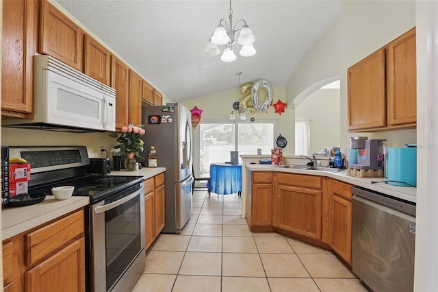 1305 Rebecca Dr, Haines City, FL 33844 - kitchen featuring stainless steel appliances, a sink, a chandelier, vaulted ceiling, and light countertops