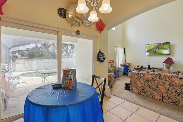 1305 Rebecca Dr, Haines City, FL 33844 - carpeted dining area with a chandelier and tile patterned flooring
