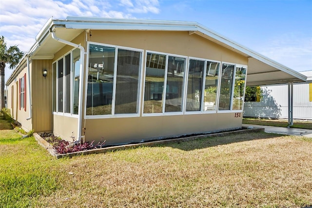 151 Lookout Dr, Flagler Beach, FL 32136 - view of side of property featuring a yard and a sunroom