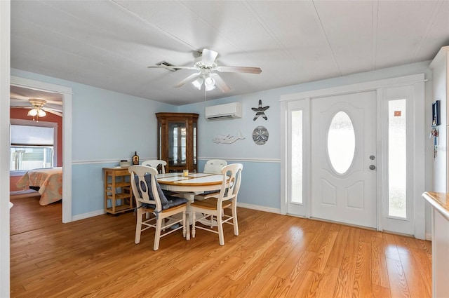 151 Lookout Dr, Flagler Beach, FL 32136 - dining space featuring ceiling fan, a wall mounted air conditioner, light wood-style floors, and baseboards