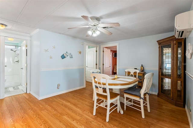 151 Lookout Dr, Flagler Beach, FL 32136 - dining space with light wood-type flooring, a wall unit AC, baseboards, and a ceiling fan