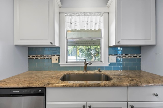 151 Lookout Dr, Flagler Beach, FL 32136 - kitchen featuring stainless steel dishwasher, a sink, white cabinetry, backsplash, and stone counters