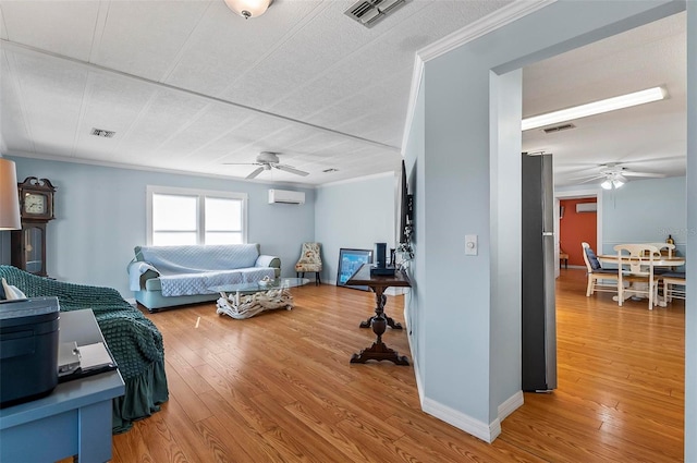 151 Lookout Dr, Flagler Beach, FL 32136 - bedroom with freestanding refrigerator, an AC wall unit, wood finished floors, baseboards, and ceiling fan