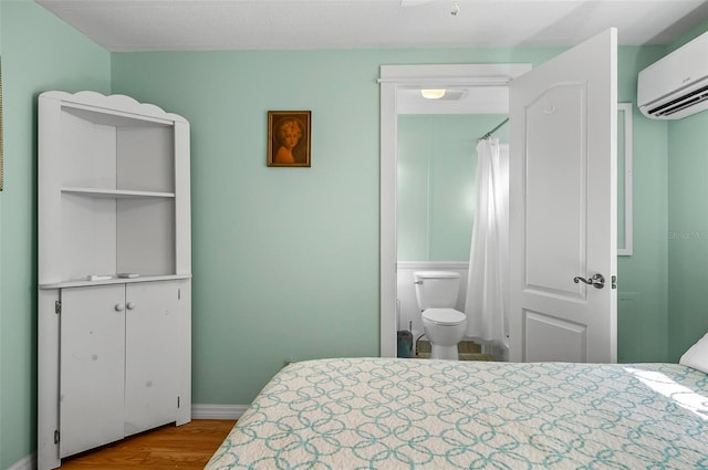 151 Lookout Dr, Flagler Beach, FL 32136 - bedroom with a wall mounted AC and wood finished floors