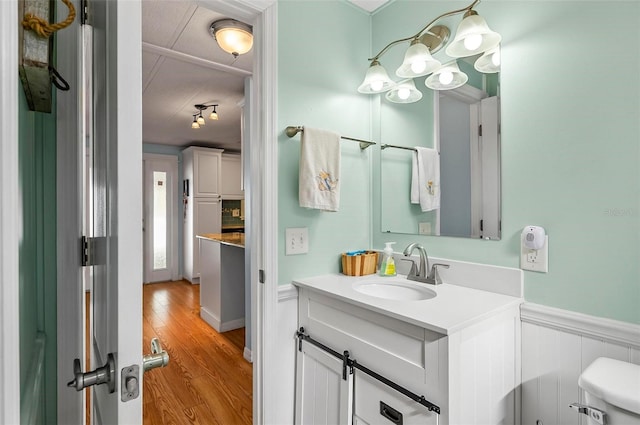151 Lookout Dr, Flagler Beach, FL 32136 - bathroom with wainscoting, wood finished floors, vanity, and toilet