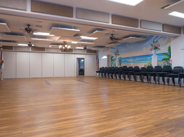151 Lookout Dr, Flagler Beach, FL 32136 - workout area with a ceiling fan, wood finished floors, and a chandelier
