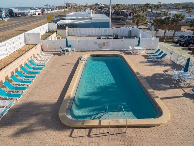 151 Lookout Dr, Flagler Beach, FL 32136 - community pool with a fenced backyard and a patio