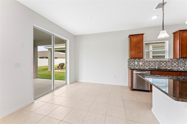 3 Oakleaf Way, Palm Coast, FL 32137 - kitchen with stainless steel dishwasher, backsplash, a sink, dark stone countertops, and hanging light fixtures