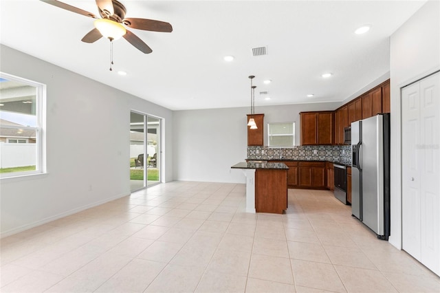 3 Oakleaf Way, Palm Coast, FL 32137 - kitchen with stainless steel fridge, healthy amount of natural light, open floor plan, stove, and recessed lighting