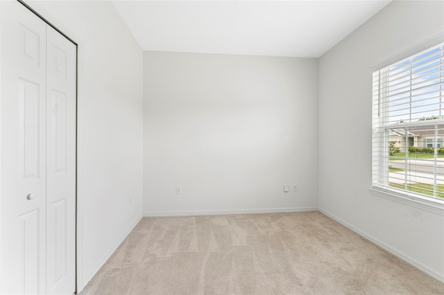 3 Oakleaf Way, Palm Coast, FL 32137 - unfurnished bedroom featuring light carpet, a closet, and baseboards