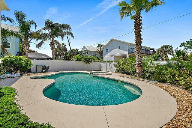 view of pool with a fenced backyard, a patio area, and a pool with connected hot tub