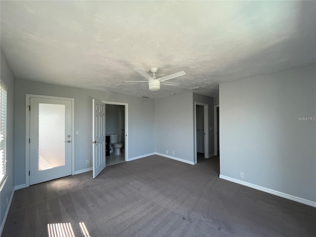 empty room featuring baseboards and a ceiling fan
