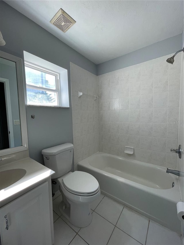 bathroom featuring tile patterned flooring, shower / tub combination, vanity, and toilet