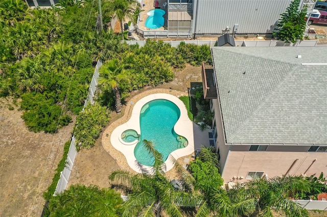 aerial view of property and surrounding area with a pool area