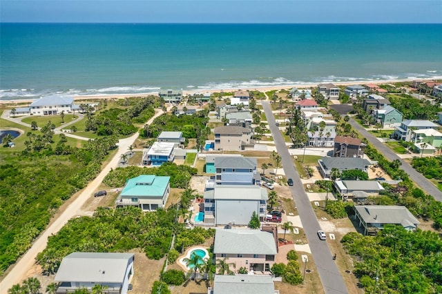 aerial view of property's location with expansive beach and nearby suburban area